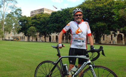 Emeritus Professor Ken Collerson with his beloved bike in UQ's Great Court.